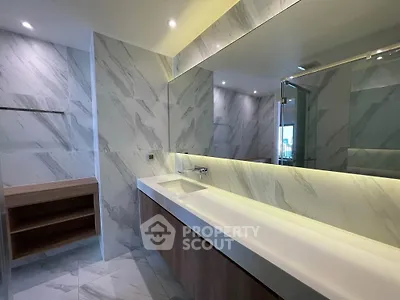 Luxurious modern bathroom with marble tiles and sleek vanity