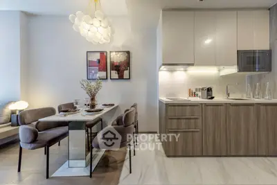 Modern kitchen and dining area with sleek cabinetry and stylish lighting