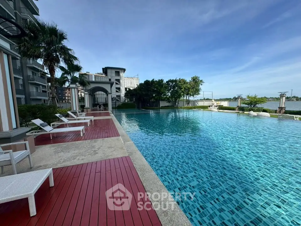 Luxurious poolside view with modern amenities and serene surroundings in a high-end residential complex.