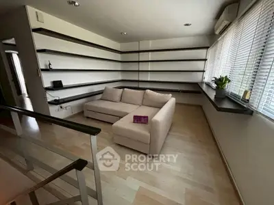 Modern living room with sleek shelving and cozy sectional sofa