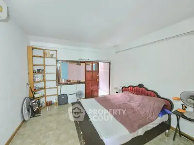 Spacious bedroom with vintage bed and ample storage space