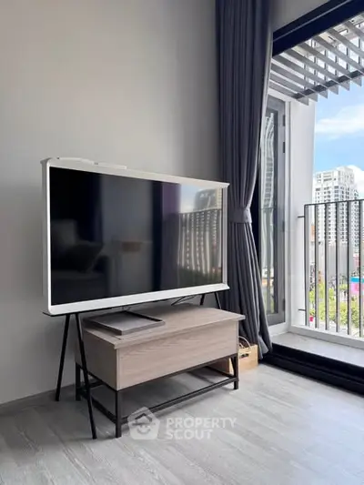 Modern living room with sleek TV stand and city view balcony, perfect for urban living.