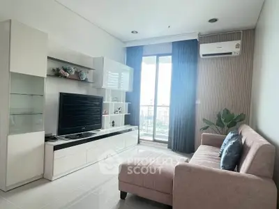 Modern living room with sleek furniture and large window offering natural light.