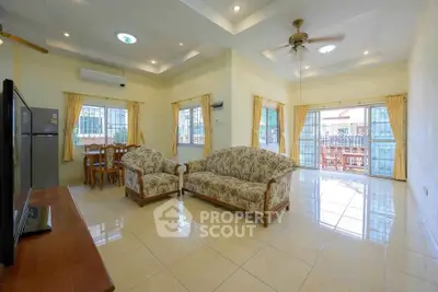 Spacious living room with elegant furniture and abundant natural light, perfect for family gatherings.