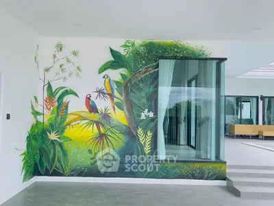 Stunning modern interior with vibrant nature-themed wall art and glass architectural feature.