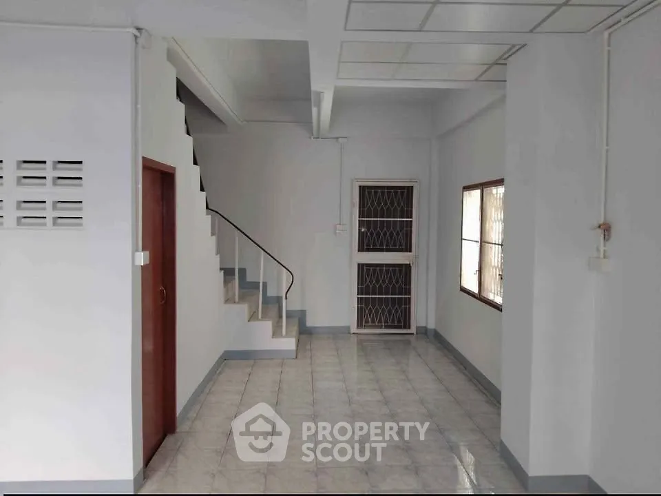 Spacious interior with staircase and tiled flooring, ideal for modern living.