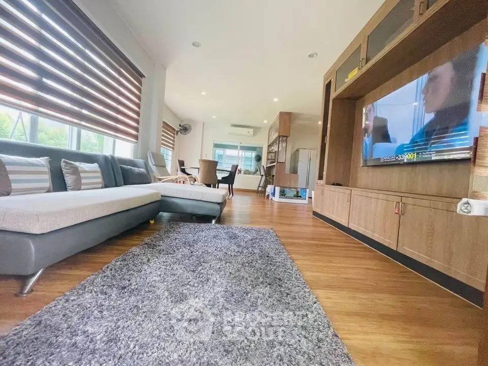 Spacious modern living room with stylish decor and large windows