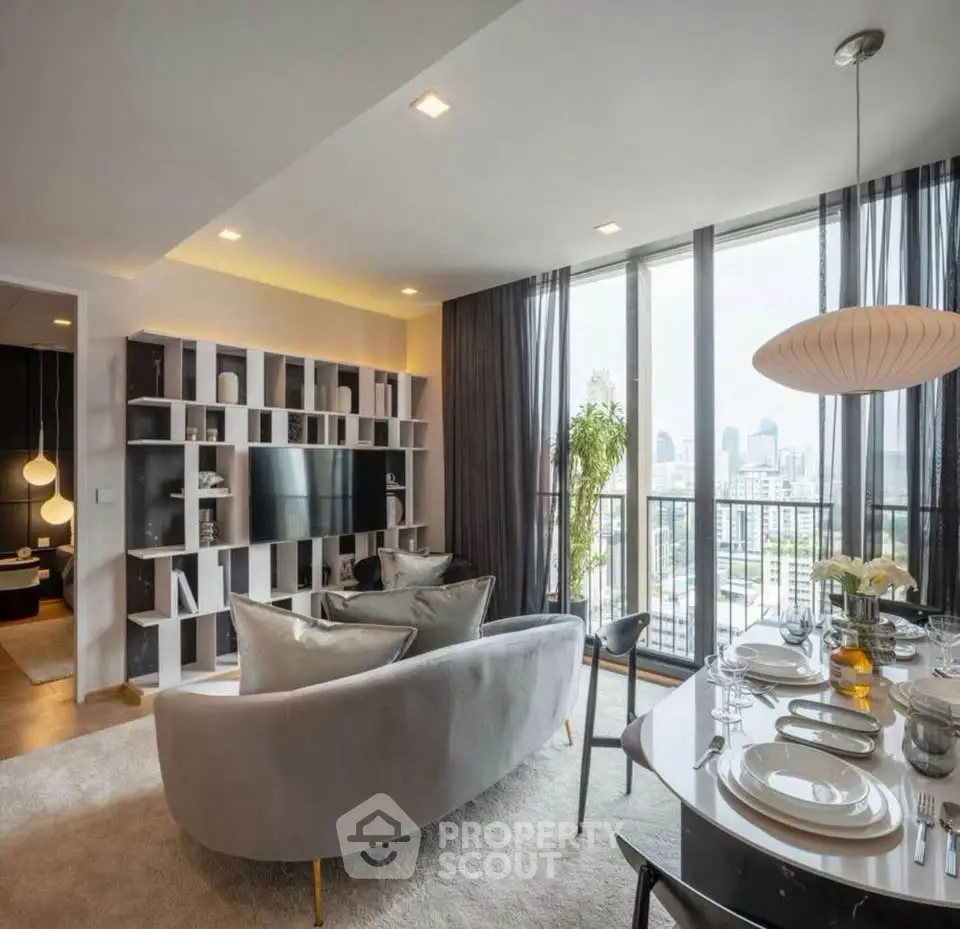 Luxurious modern living room with city view, elegant decor, and open dining area.