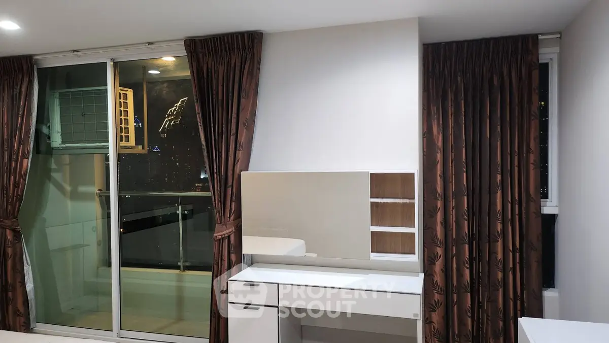 Modern apartment interior with balcony access and stylish curtains