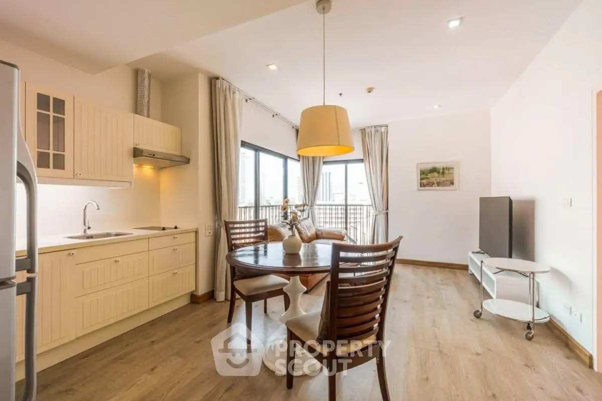 Spacious open-layout kitchen and living area with modern furnishings and natural light.