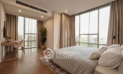Spacious modern bedroom with large windows and elegant decor
