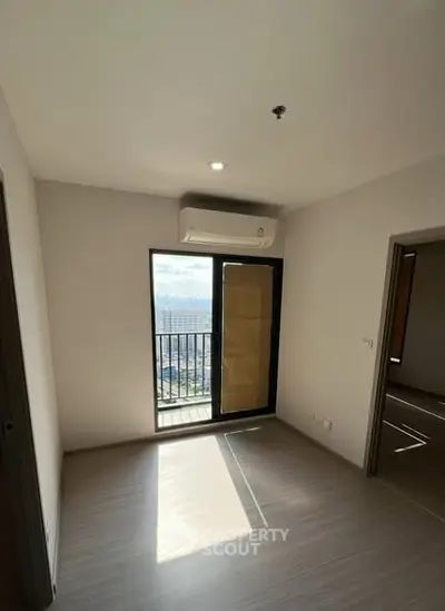 Bright empty room with balcony and air conditioning in modern apartment