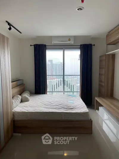 Modern bedroom with city view, featuring sleek wooden furniture and large window for natural light.