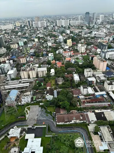 Stunning aerial view of urban cityscape showcasing diverse architecture and lush greenery.