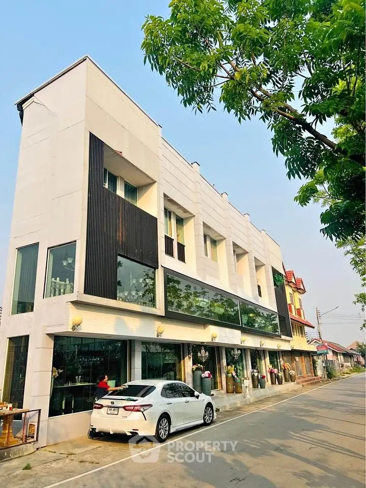 Modern multi-story building with sleek design and large windows, ideal for commercial or residential use.