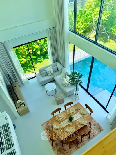 Luxurious open-plan living room with pool view and elegant dining area, perfect for modern living.