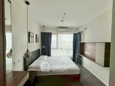 Modern bedroom with large window and stylish decor in high-rise apartment.