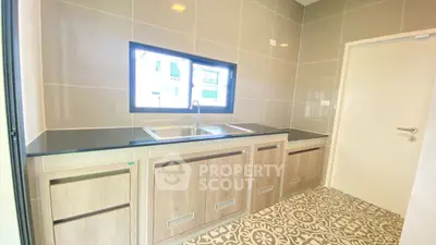 Modern kitchen with sleek cabinetry and patterned tile flooring
