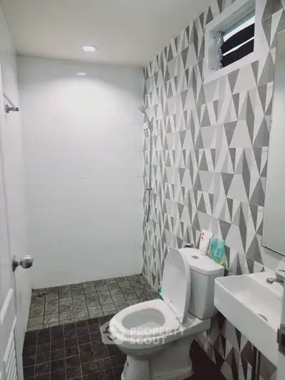 Modern bathroom with geometric tile design and sleek fixtures
