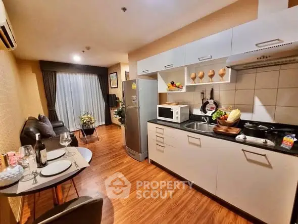 Modern kitchen with open layout and dining area in cozy apartment