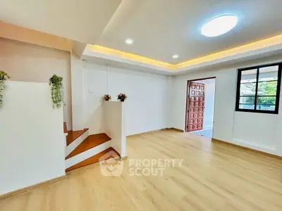 Spacious modern living room with wooden flooring and stylish ceiling lights