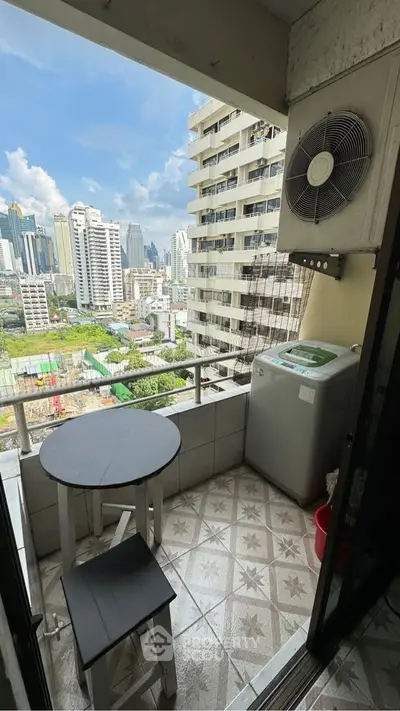 Charming balcony with city view, featuring compact seating and washing machine, perfect for urban living.