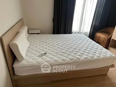 Spacious bedroom with modern wooden bed frame and natural light from large window.