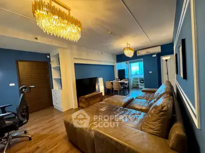 Luxurious living room with elegant chandeliers and plush leather sofa