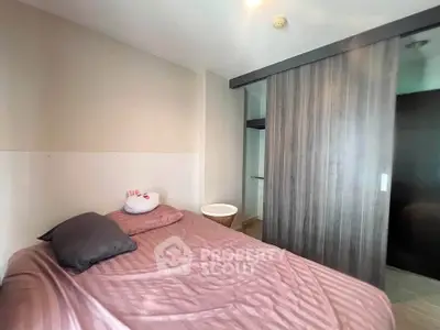Cozy bedroom with modern sliding wardrobe and plush bedding in a stylish apartment.