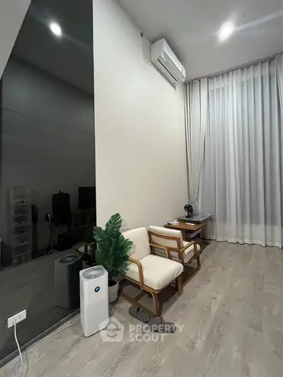 Modern minimalist living room with air conditioner and stylish furniture