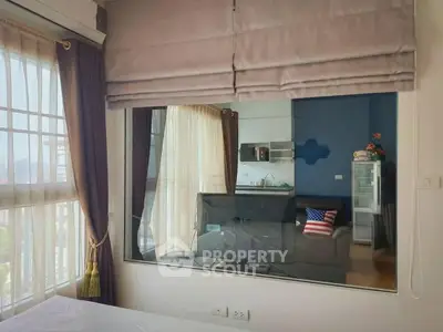 Modern apartment interior with large window and cozy living area