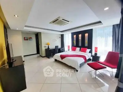 Spacious modern bedroom with stylish decor and ample natural light