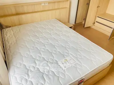 Spacious bedroom with a comfortable mattress and ample storage space.