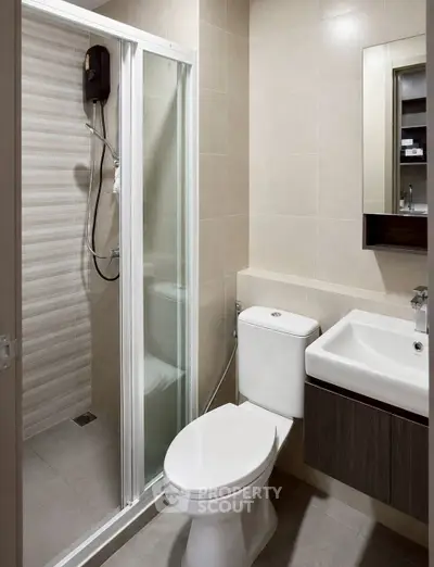 Modern bathroom with shower enclosure and sleek fixtures in a contemporary apartment.