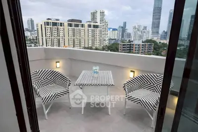 Chic urban balcony with stylish seating and stunning cityscape view