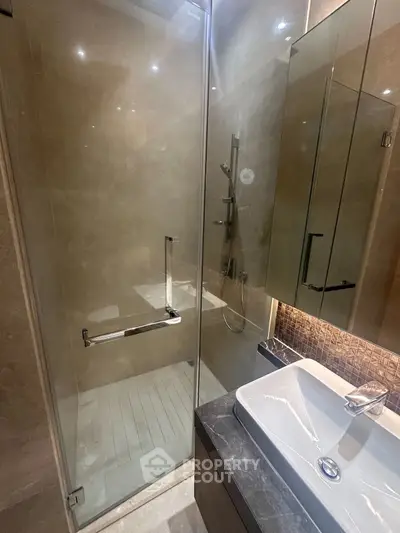 Modern bathroom with glass shower and sleek sink design