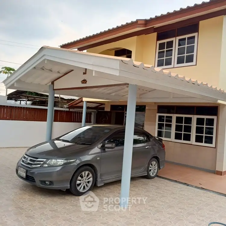 Charming two-story house with covered carport and tiled driveway