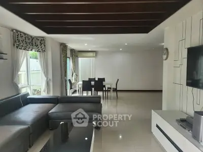 Spacious modern living room with elegant decor and large windows for natural light.