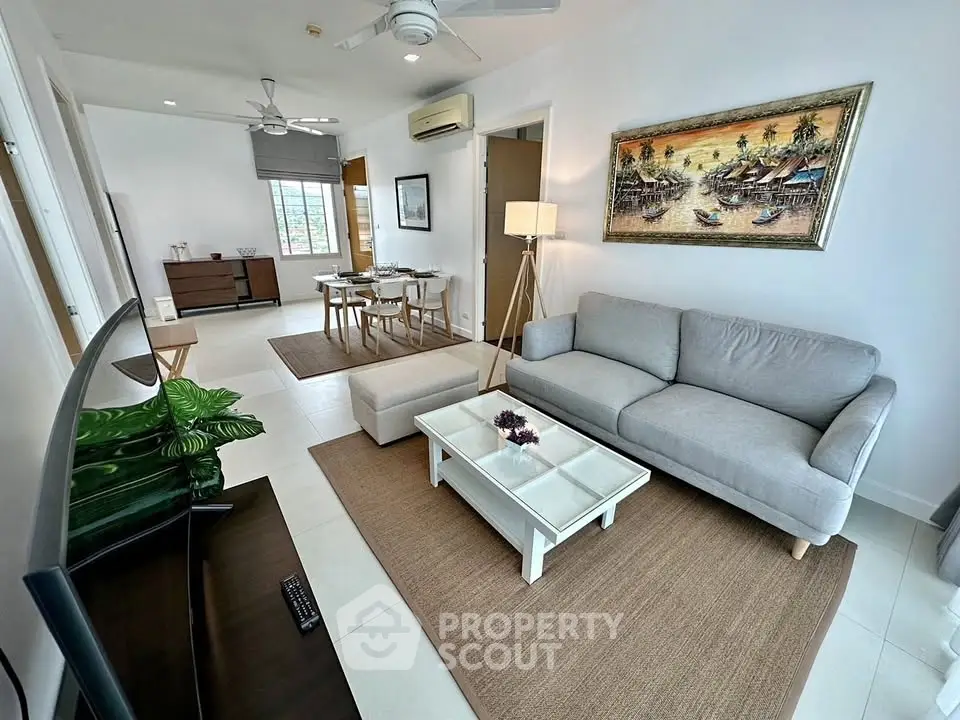 Stylish living room with modern decor and cozy seating in a bright apartment.