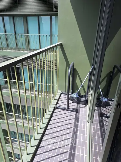 Modern apartment balcony with sleek railing and city view