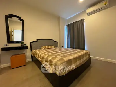 Cozy bedroom with modern decor and air conditioning, perfect for relaxation and comfort.