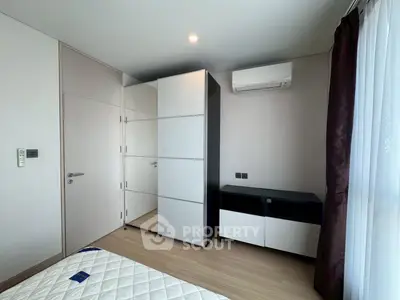 Modern bedroom with sleek wardrobe and air conditioning