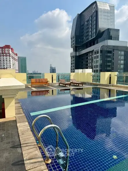 Stunning rooftop pool with city skyline views and modern architecture.