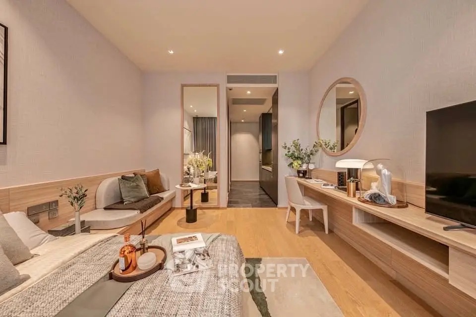 Modern living room with stylish decor and cozy ambiance, featuring a sleek TV setup and elegant furnishings.