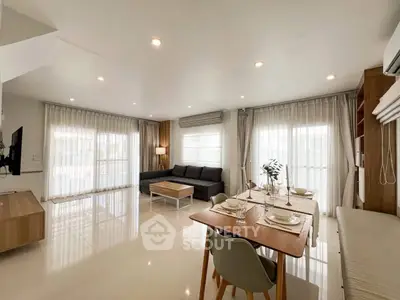 Spacious modern living room with dining area and natural light