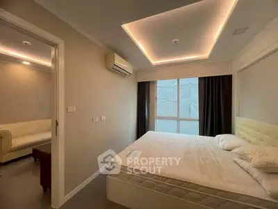 Modern bedroom with stylish lighting and large window in a contemporary apartment.