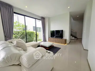 Modern living room with large windows and stylish furniture