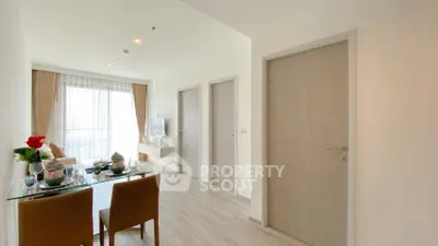 Modern apartment interior with dining area and living room, featuring elegant decor and natural light.