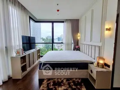 Luxurious bedroom with city view, modern decor, and large windows for natural light.