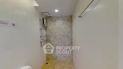Modern bathroom with tiled shower area and sleek fixtures
